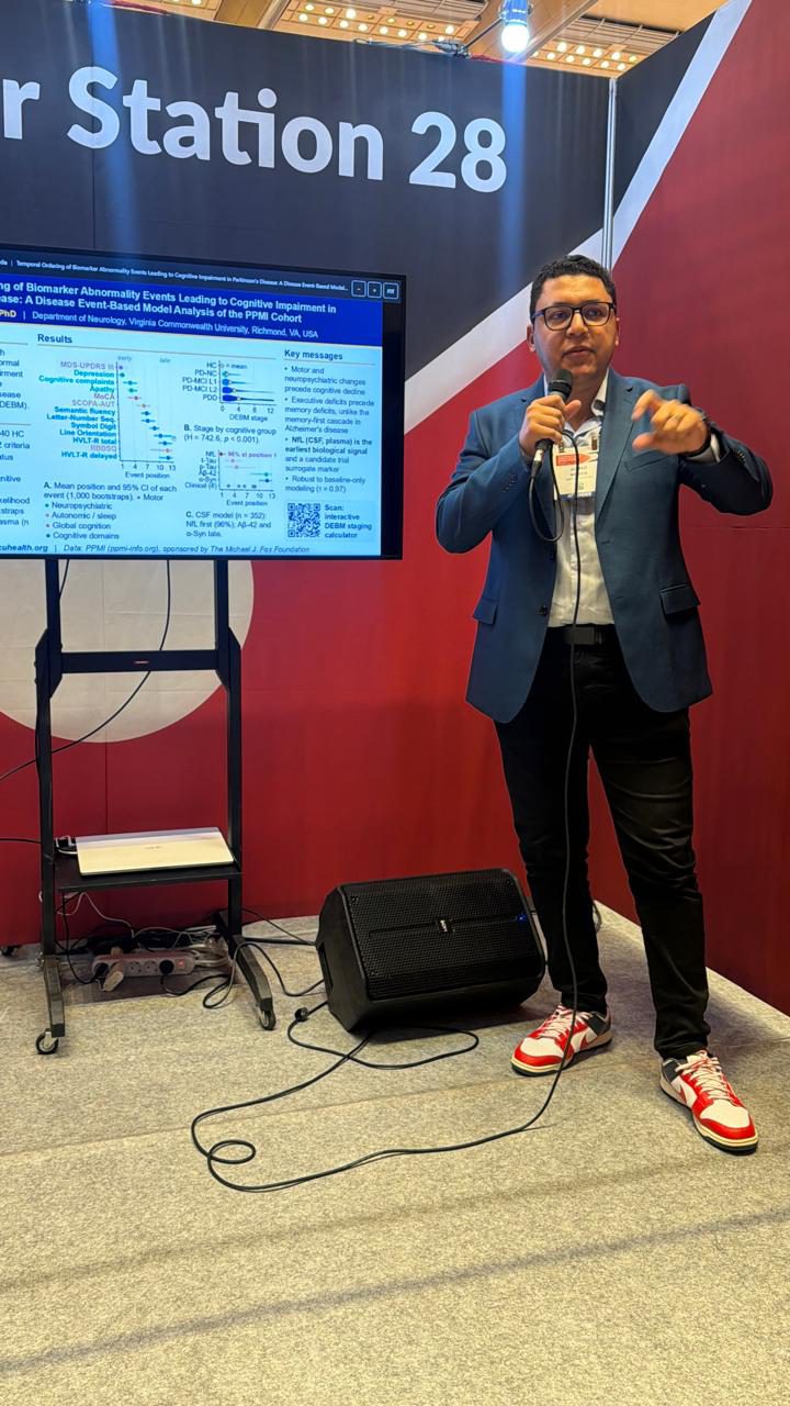 Ahmed Negida presenting at a poster station at the MDS Congress 2026